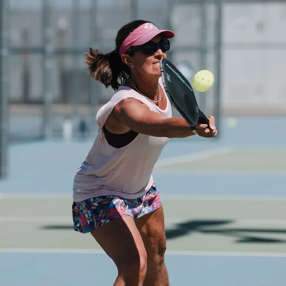 Pickleball player making a controlled forehand shot near the non-volley zone